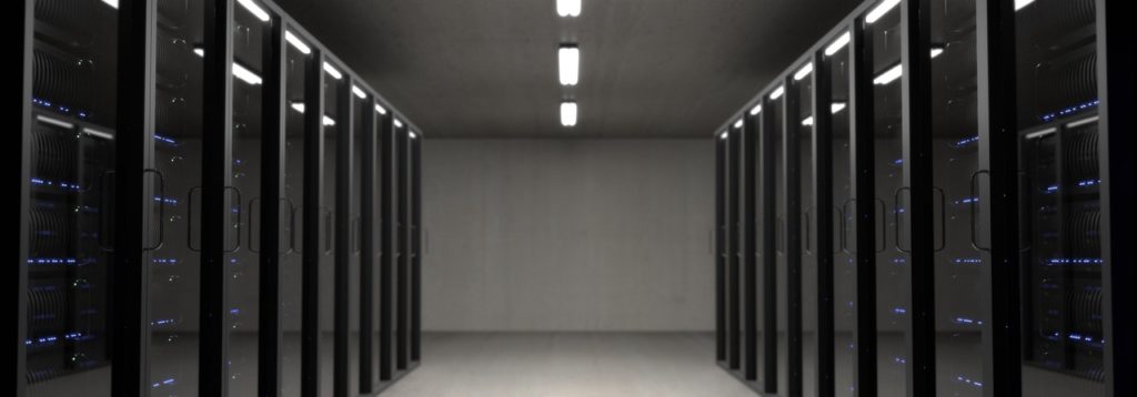 Hallway lined by computer servers.