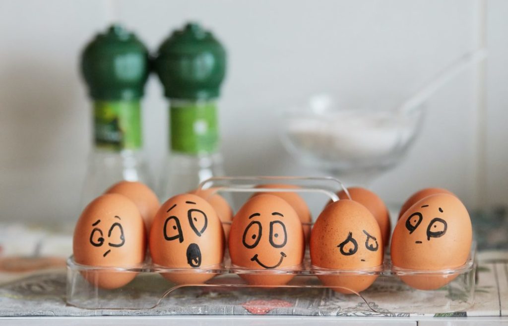 Five painted eggs expressing different emotions.